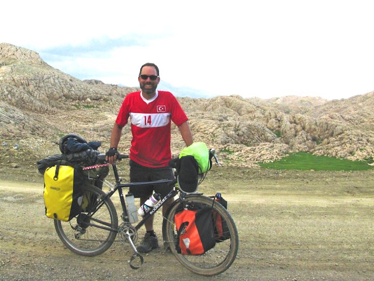 Ben F behind his bike, posing from the top of a Turkish mountain